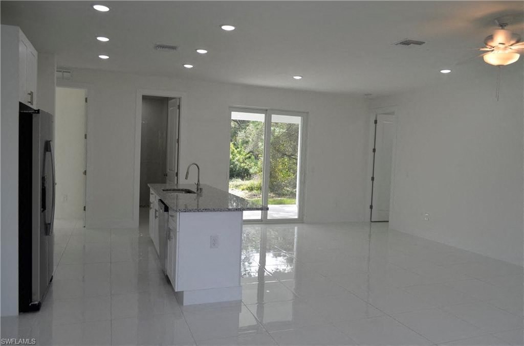 an empty kitchen with an island in the middle of it