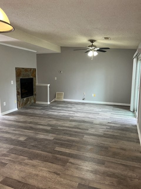 a living room with a wood floor and a ceiling fan