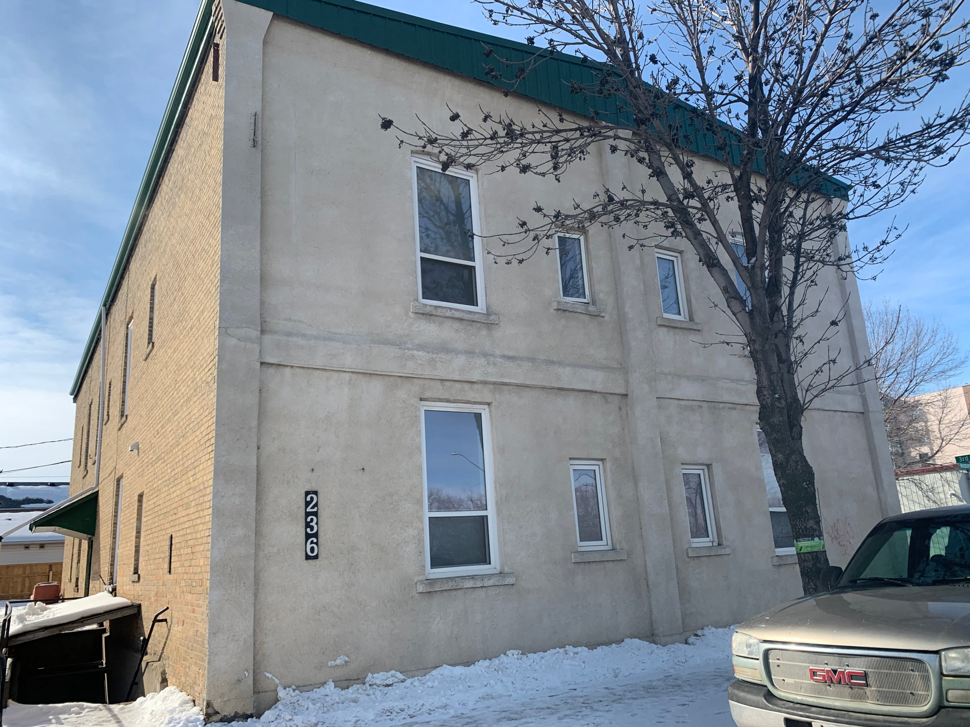 a building with a tree in front of it in the snow