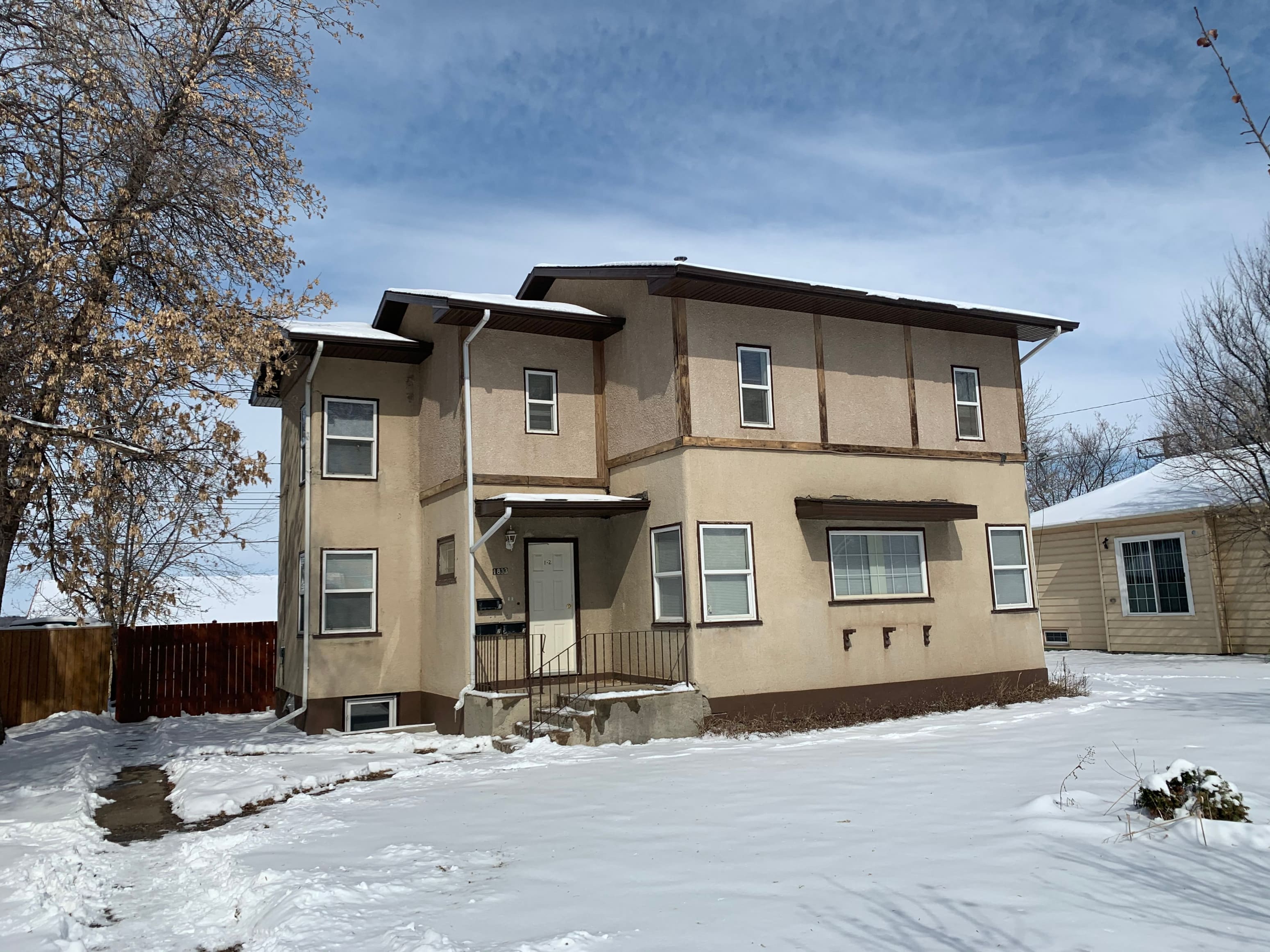 a tan house with a lot of snow