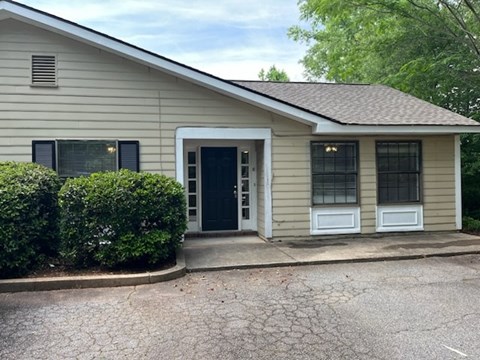A house with a black door and a small front porch.
