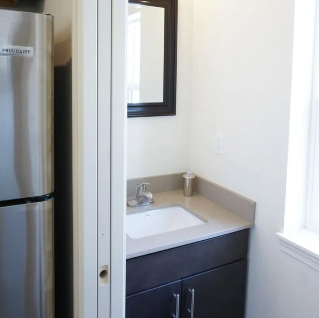 a small bathroom with a sink and a mirror