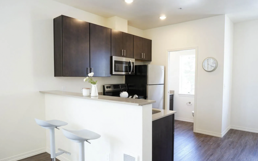 a kitchen with a counter top and a refrigerator