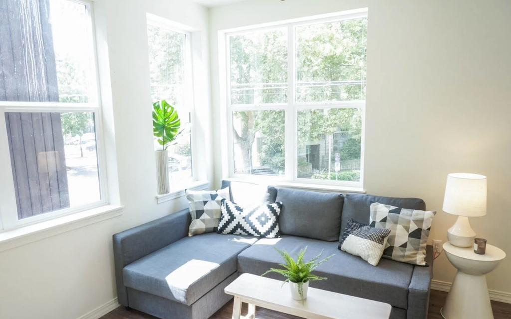 a living room with a couch and large windows
