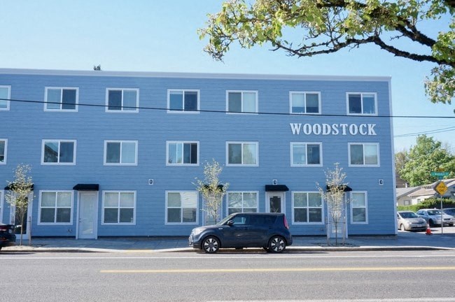 a blue building with a car parked in front of it