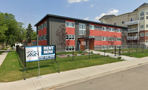 a rent now sign in front of an apartment building