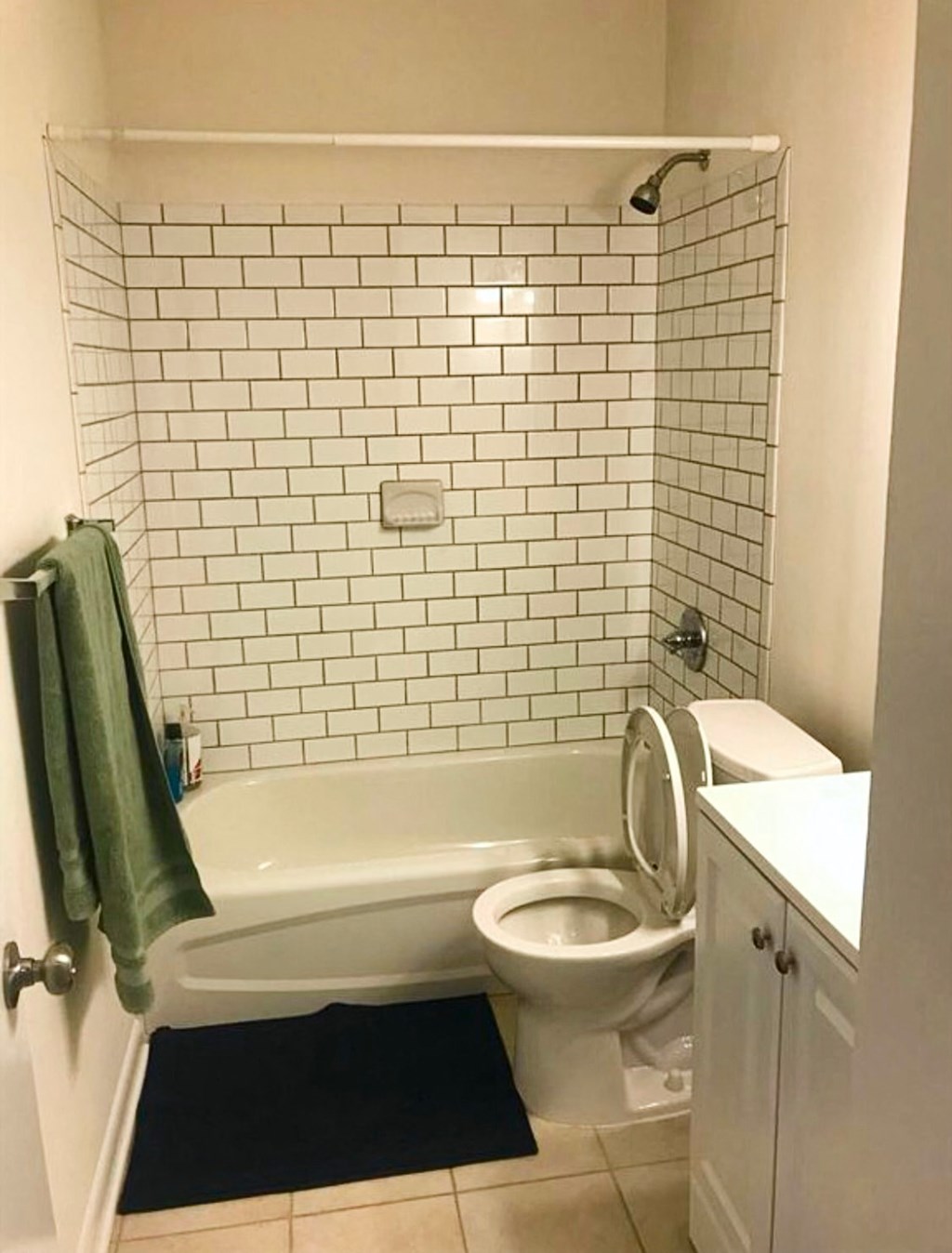 a bathroom with a toilet and a tub and a sink