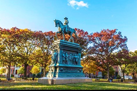 a statue of a man riding a horse in a park