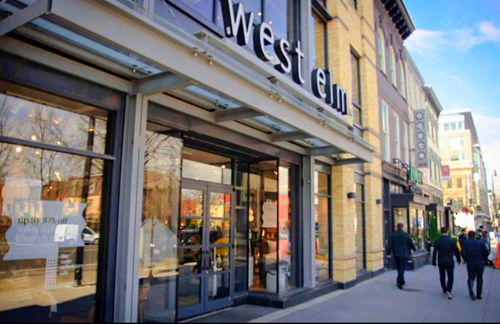 the facade of the west elm store on a city street