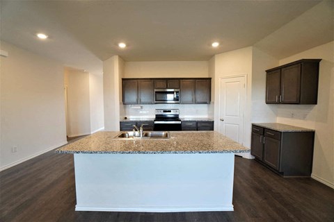 a kitchen with a granite counter top and a