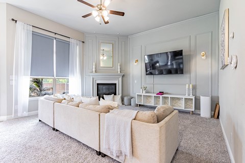 a living room with a large couch and a fireplace