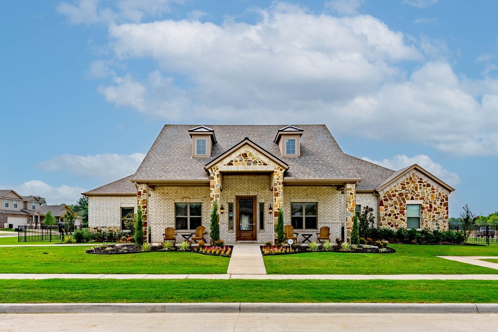 a house with a lawn and a sidewalk in front of it