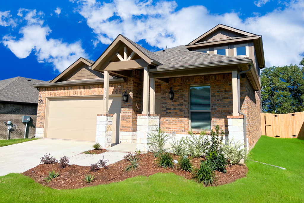 A house with a brown roof and a garage door.
