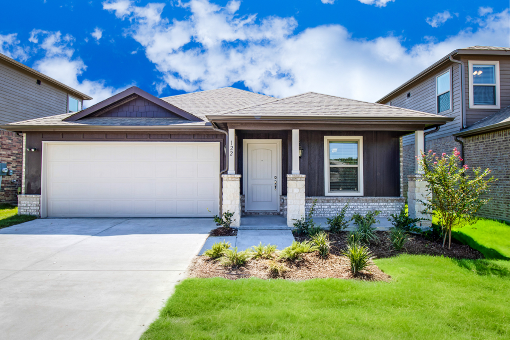 A house with a brown roof and a white garage door.