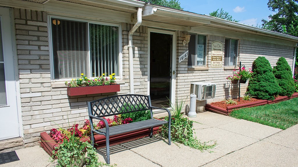 A house with a bench in front of it.