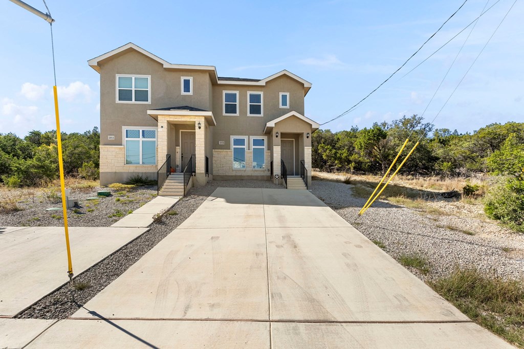 a large house with a long sidewalk in front of it