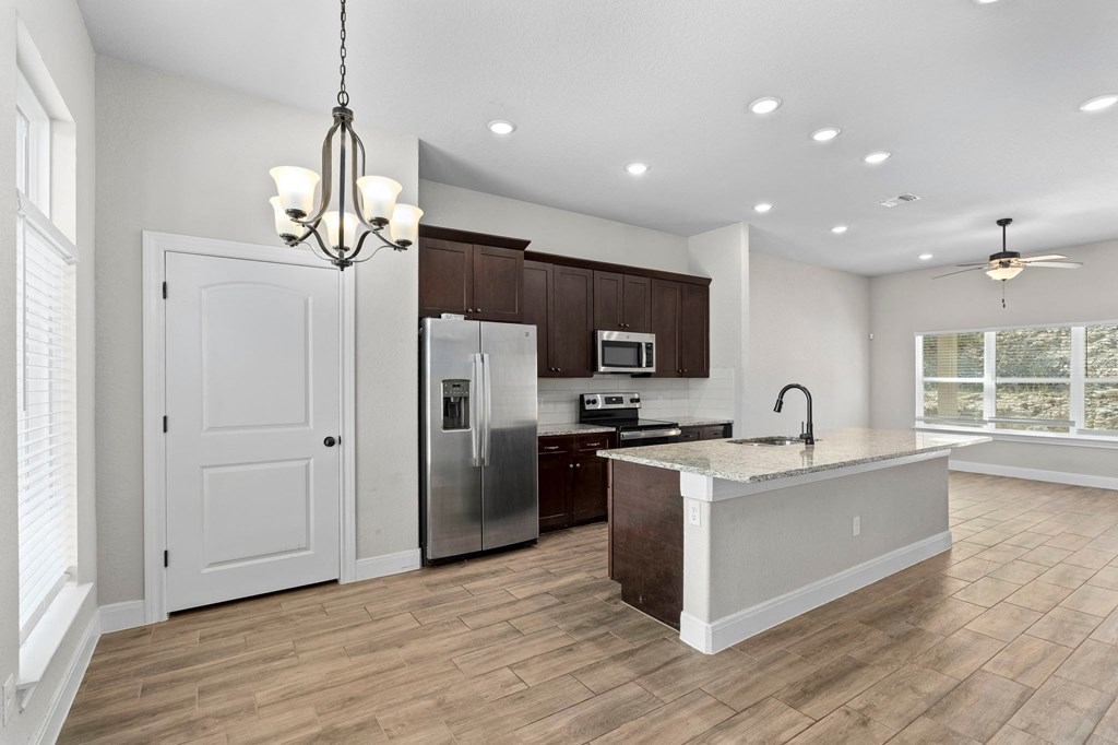 a kitchen with a large island and a refrigerator