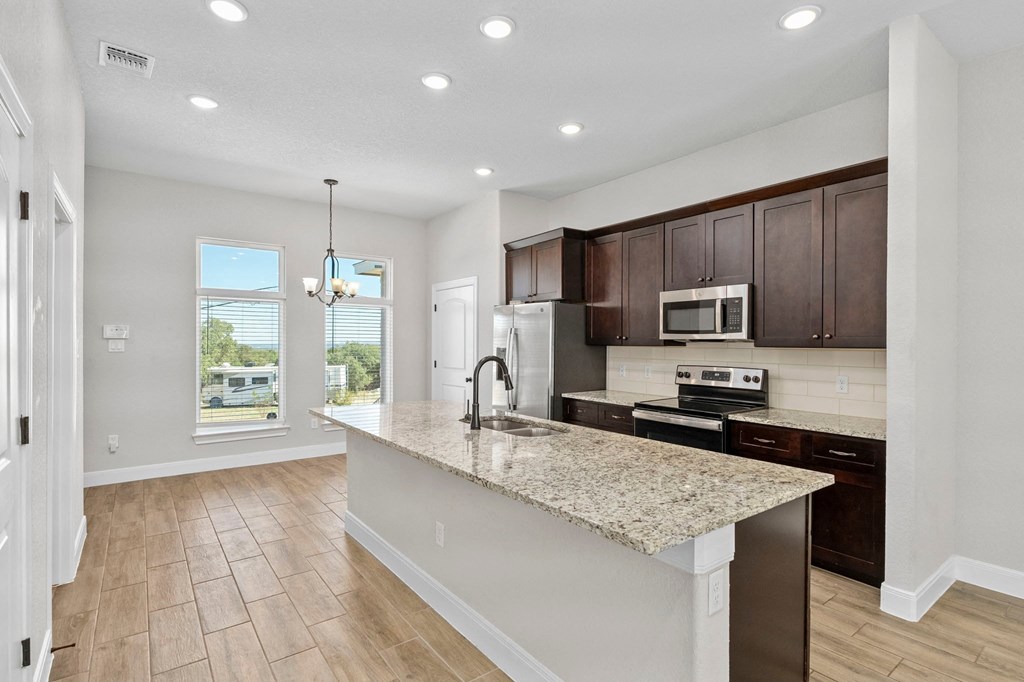 a kitchen with a marble counter top and