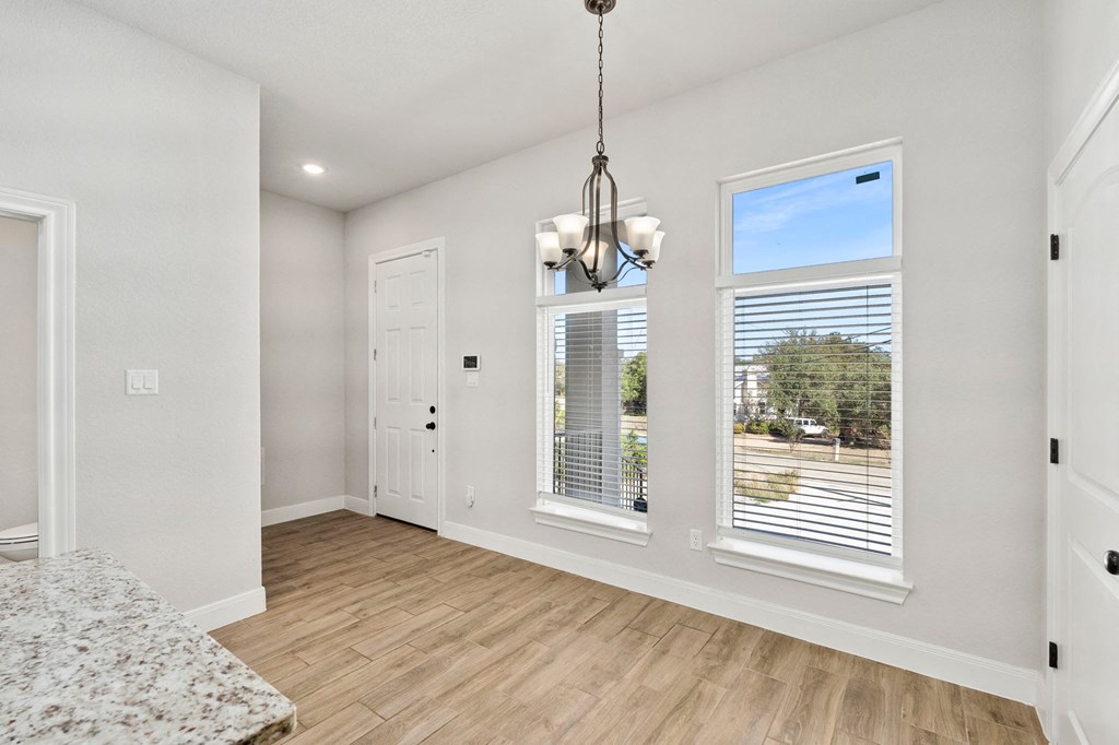 a living room with two windows and a door