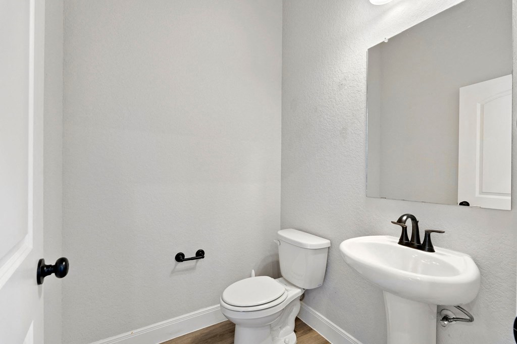 a bathroom with a sink and a toilet and a mirror
