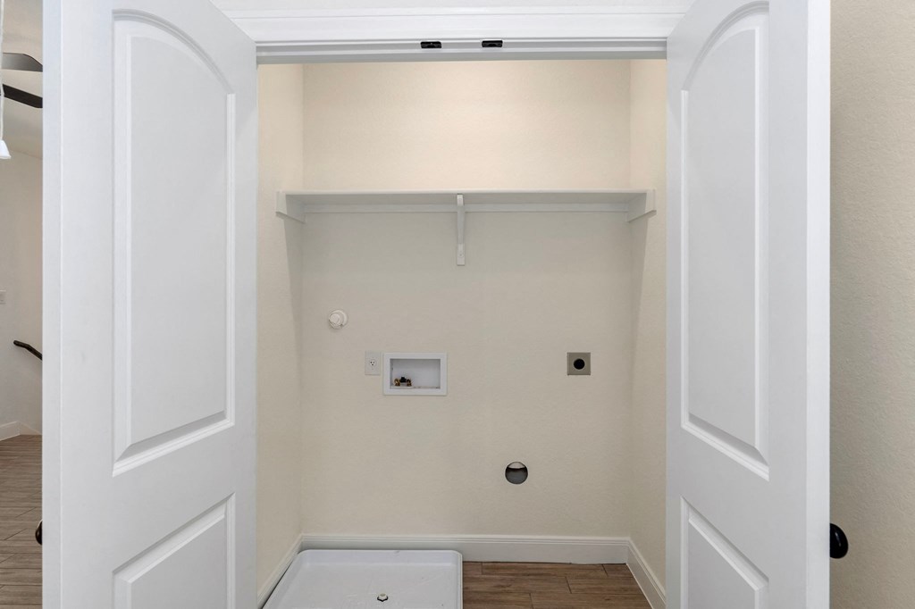 a room with a white wall and a white tub and a closet