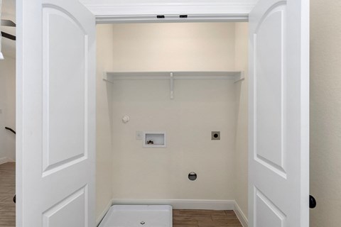 a room with a white wall and a white tub and a closet