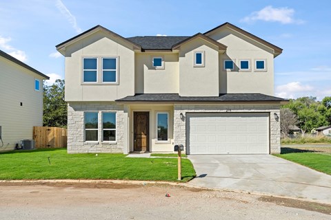 a beige house with a garage and a driveway