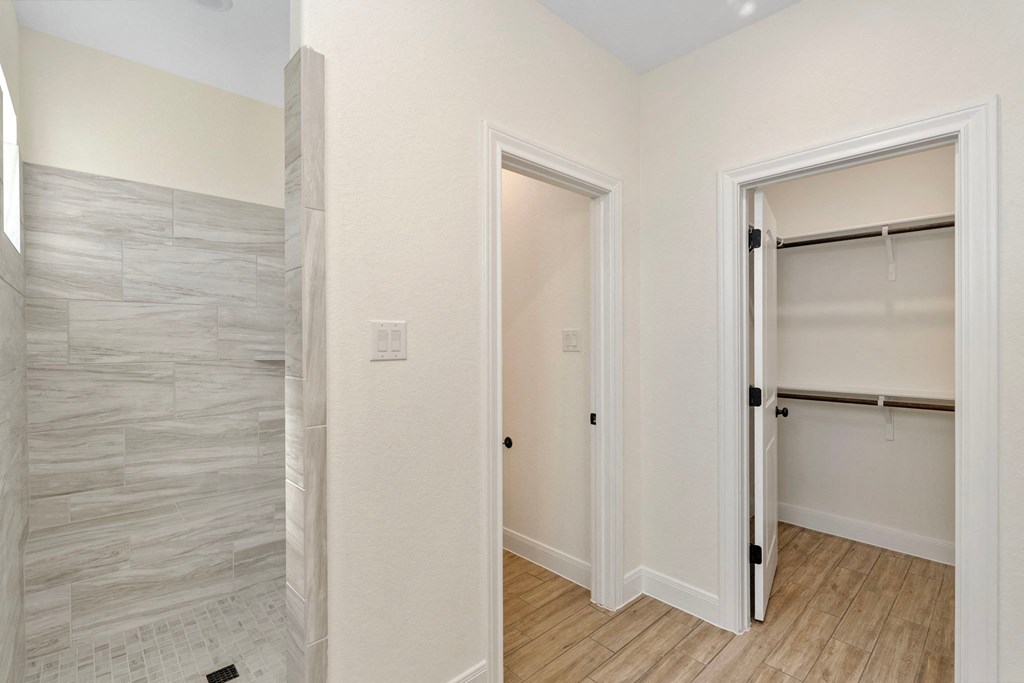 a bedroom with a closet and a door to a bathroom