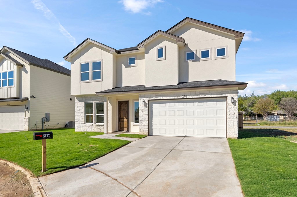 a house with a white garage door and a driveway