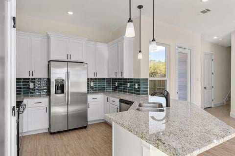 a kitchen with white cabinets and a counter top