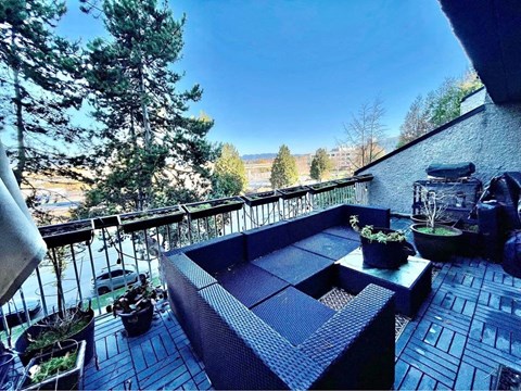 a balcony with a view of a lake and trees