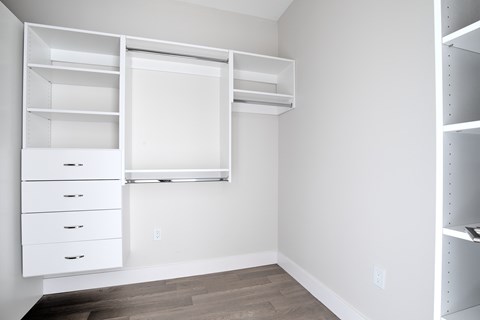 A white closet with drawers and shelves.