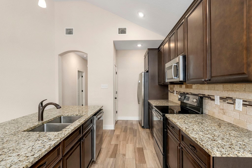 the reserve at city center spacious kitchen with granite counter tops and stainless steel appliances