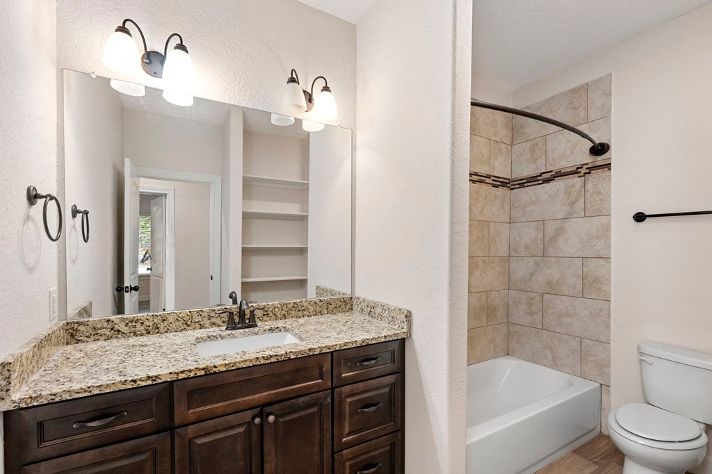 a bathroom with a sink and a toilet and a shower
