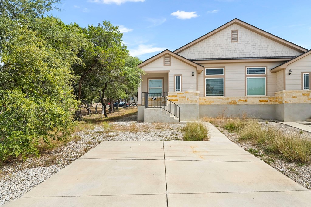 the front of a house with a sidewalk and a driveway