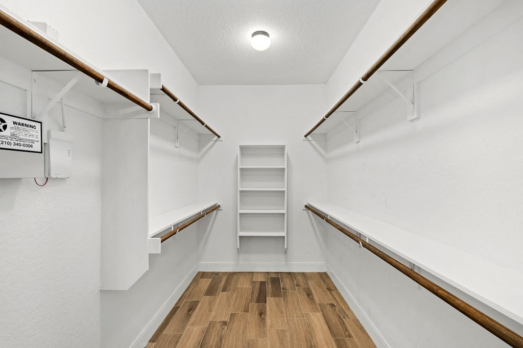 a walk in closet with shelves and a ladder