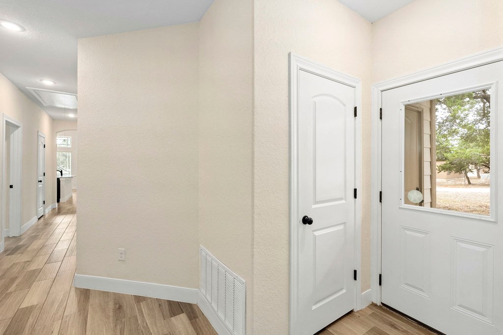 the interior of a house with white doors and a hallway