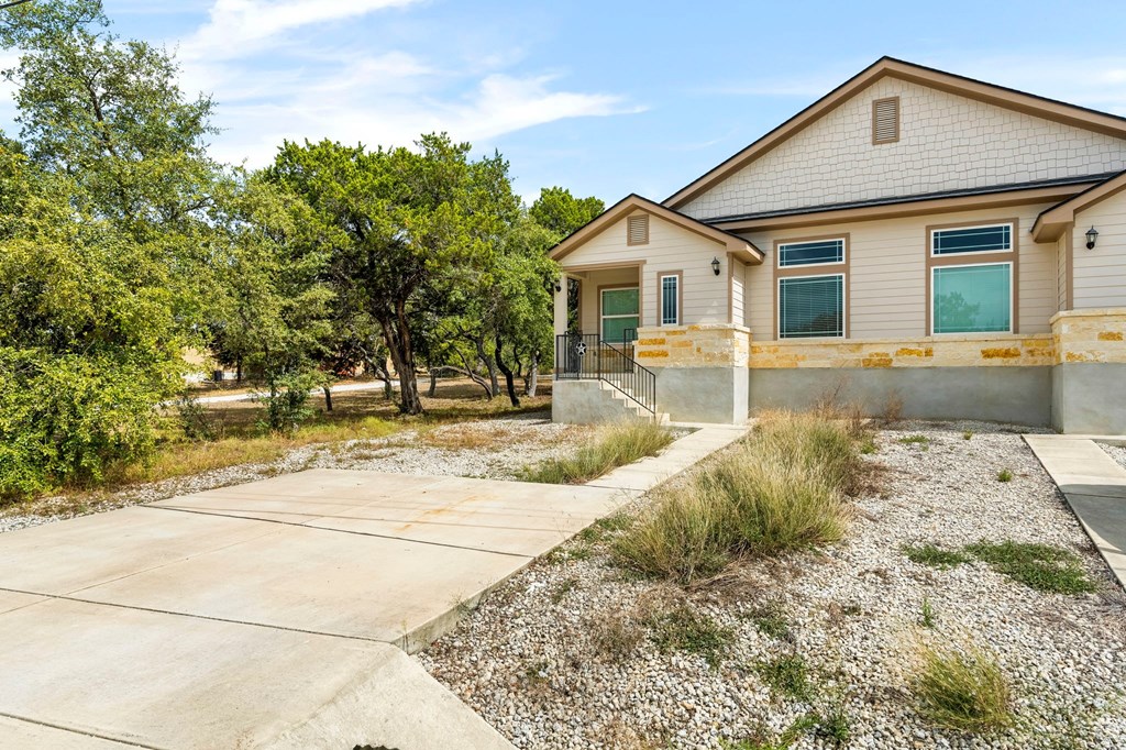 the front of a house with a sidewalk and a driveway