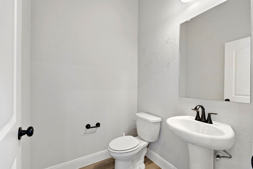 a bathroom with a sink and a toilet and a mirror