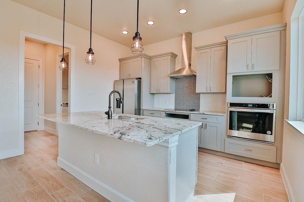 a kitchen with a large island and a microwave