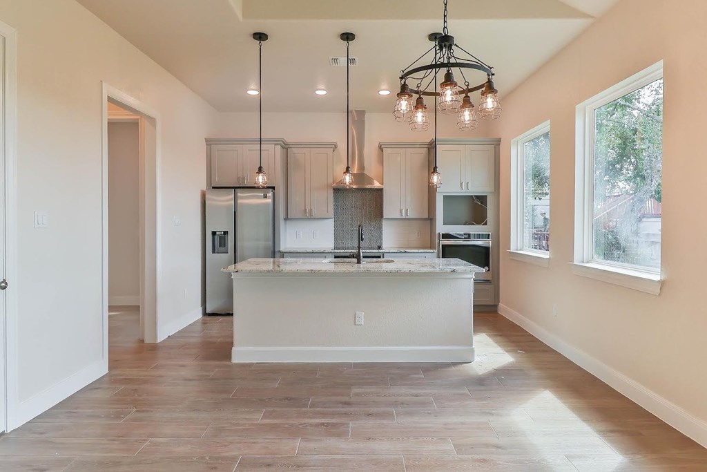 a kitchen with a large island in the middle of it