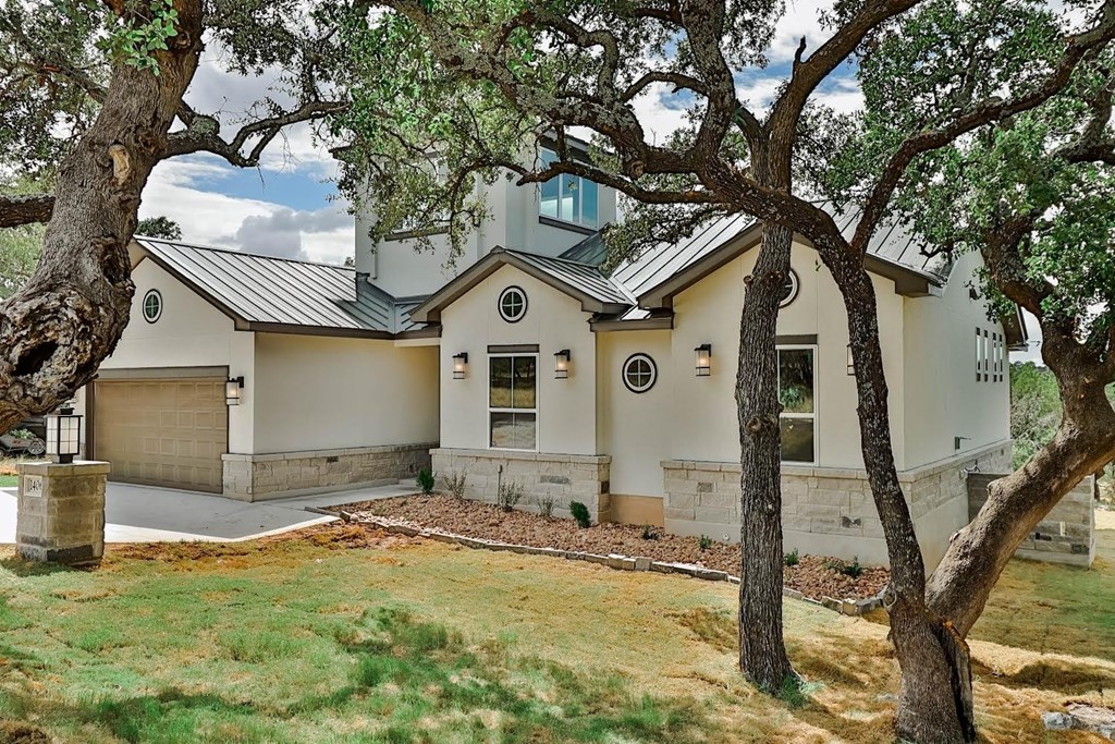 a white house with a yard and trees