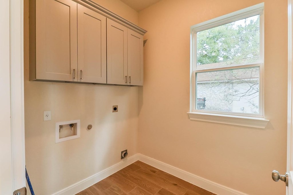 a bedroom with white cabinets and a window