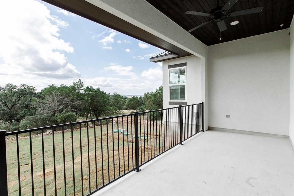 the view from the balcony of a home with a metal railing