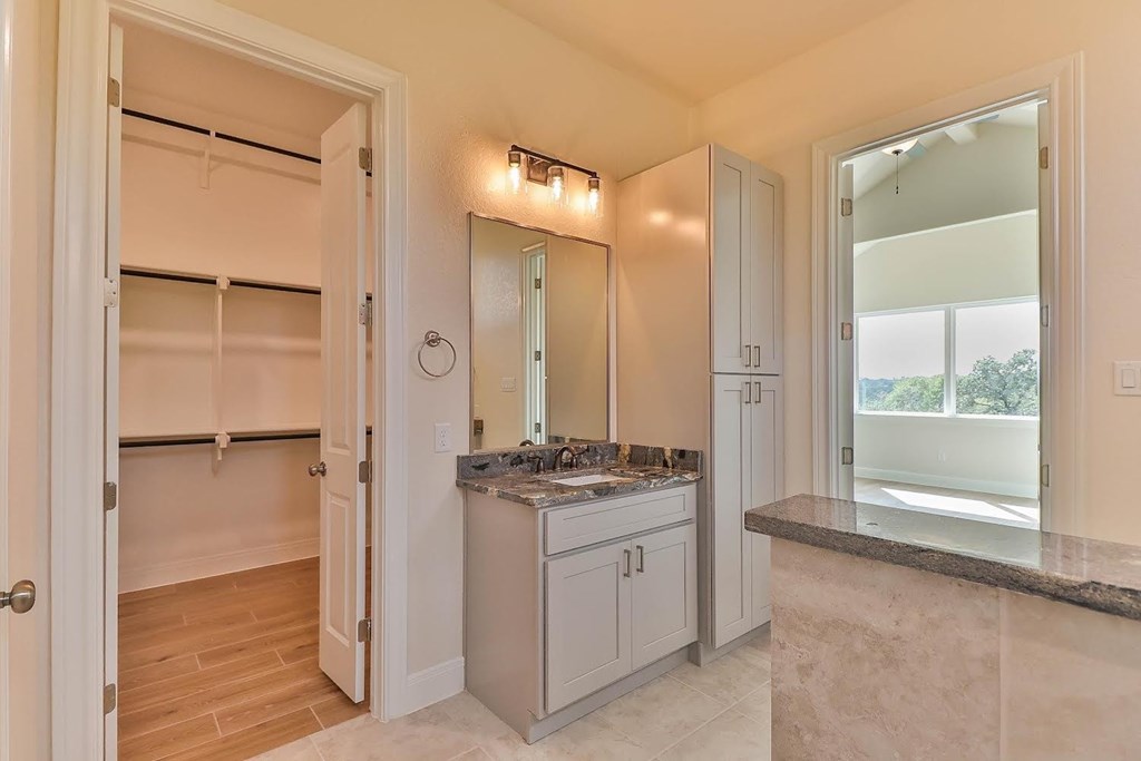 a white bathroom with a sink and a mirror