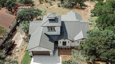 an aerial view of a house with a gray roof