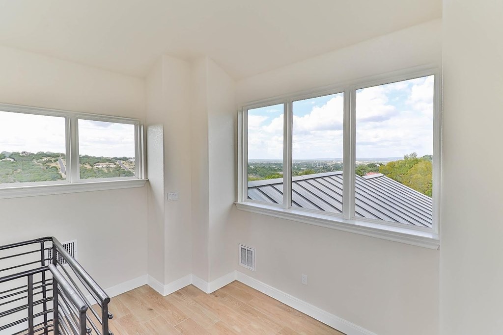 a living room with a large window and a staircase