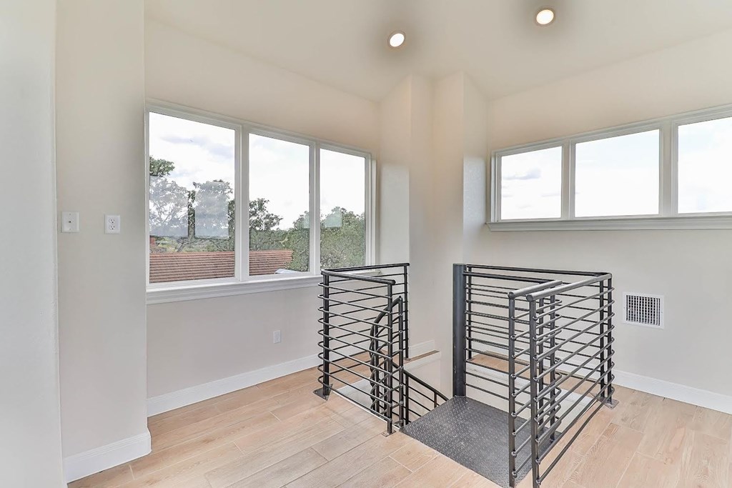 a living room with a staircase and a window