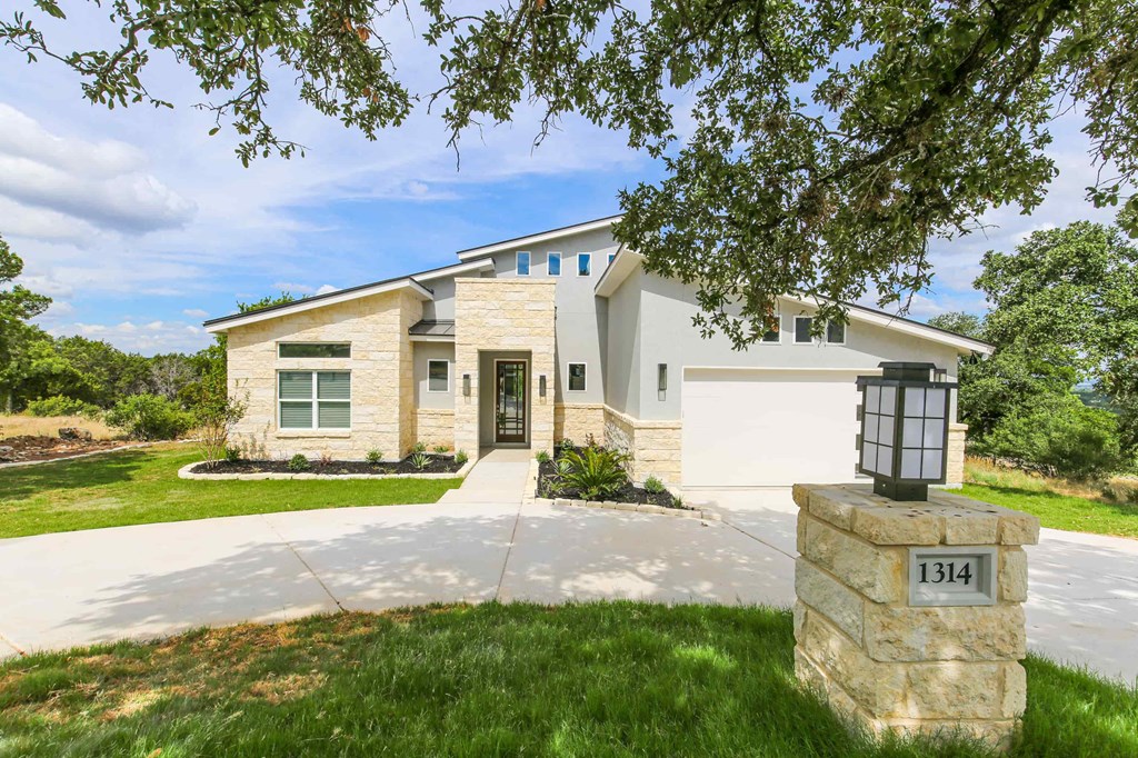 the front of a house with a driveway and a garage door