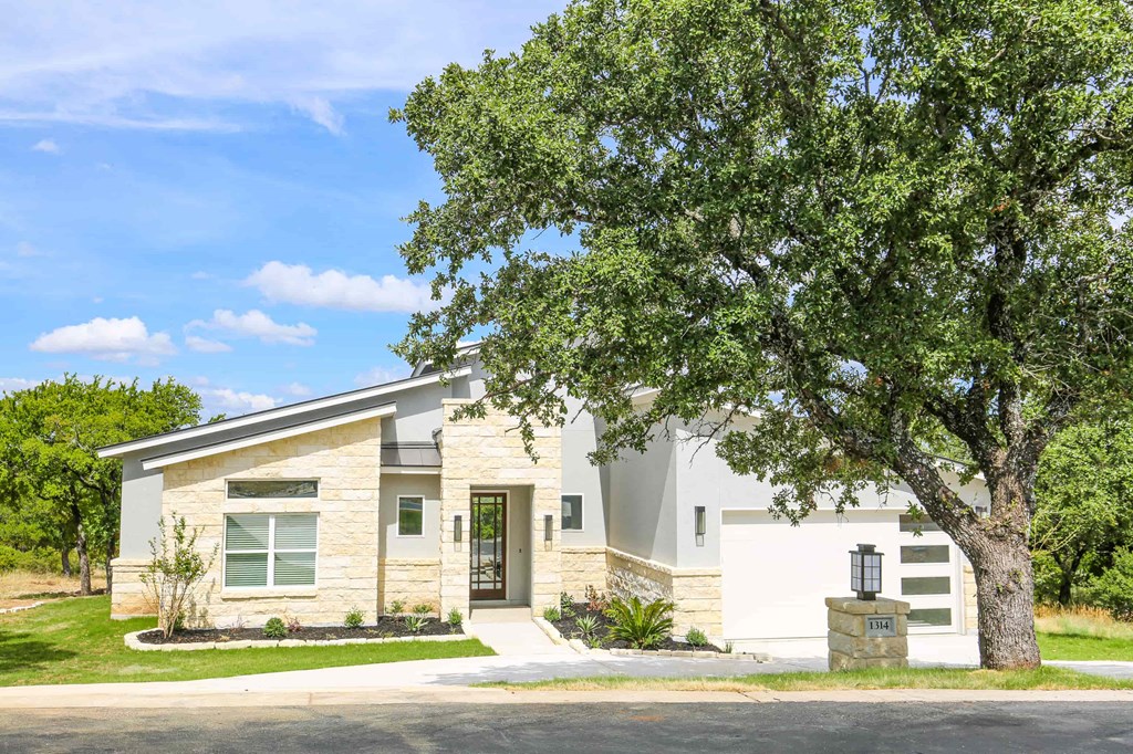 a white house with a tree in front of it
